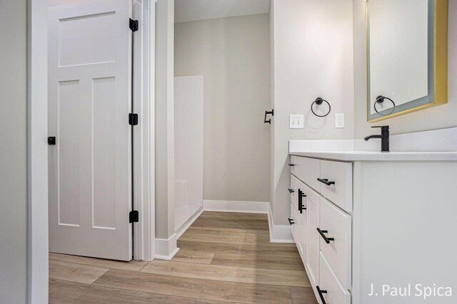 bathroom with hardwood / wood-style floors and vanity