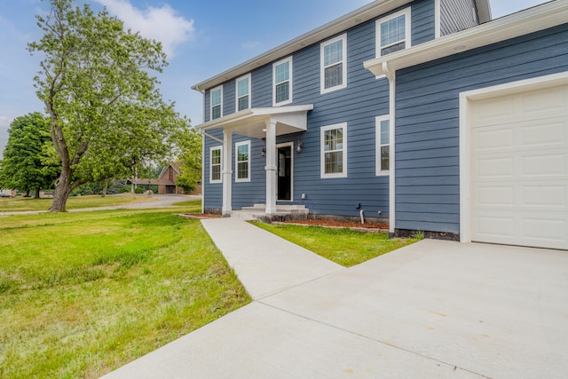 view of front facade featuring a garage and a front yard