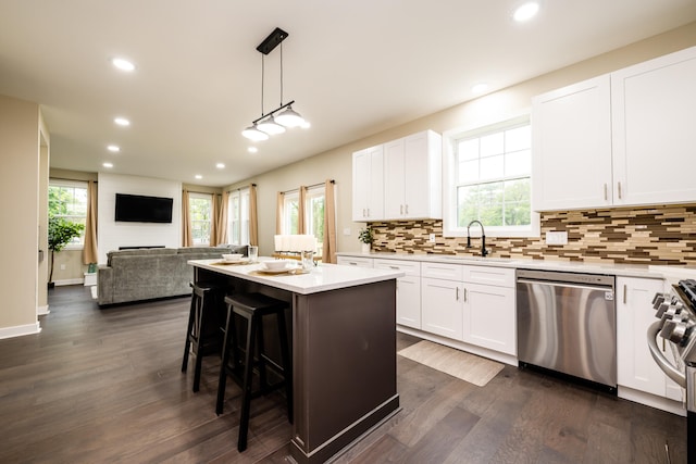 kitchen with a healthy amount of sunlight, dishwasher, and dark hardwood / wood-style flooring