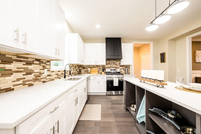 kitchen featuring dark hardwood / wood-style floors, stainless steel appliances, backsplash, hanging light fixtures, and sink