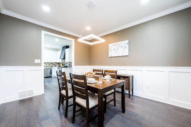 dining room featuring dark hardwood / wood-style flooring and crown molding