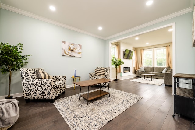 living room with dark hardwood / wood-style flooring and ornamental molding