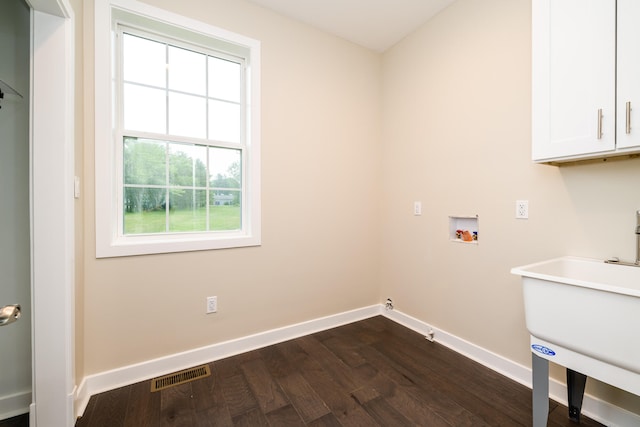 clothes washing area with cabinets, dark hardwood / wood-style flooring, and hookup for a washing machine