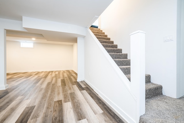 staircase with hardwood / wood-style flooring