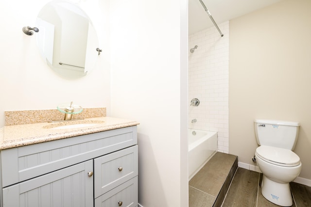 full bathroom featuring tiled shower / bath combo, toilet, hardwood / wood-style flooring, and vanity