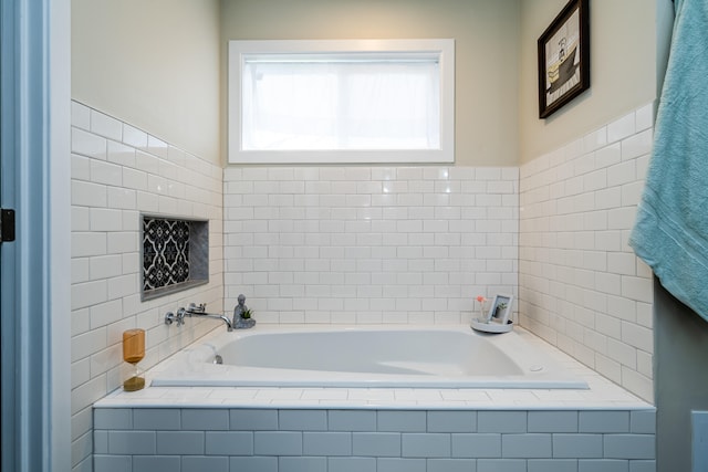 bathroom with tile walls and tiled tub