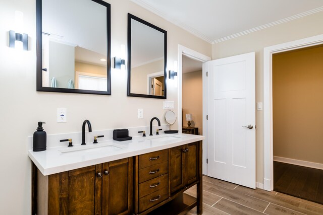 bathroom featuring wood-type flooring, double vanity, and ornamental molding