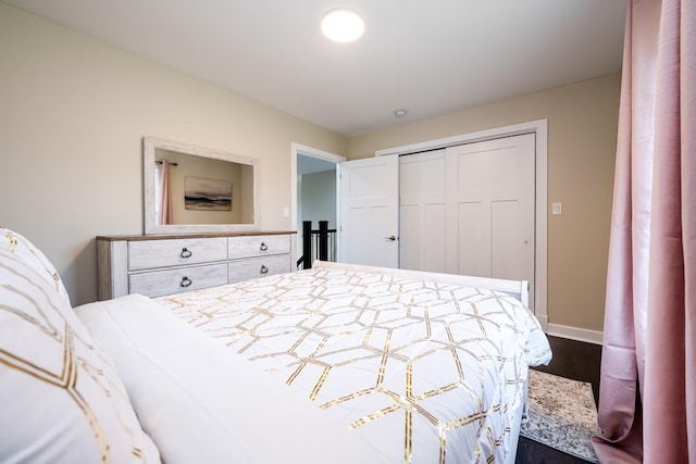 bedroom with a closet and dark hardwood / wood-style floors