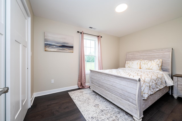 bedroom featuring dark hardwood / wood-style flooring