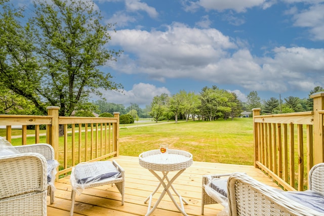 wooden terrace featuring a lawn