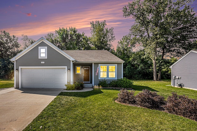 view of front facade with a lawn and a garage