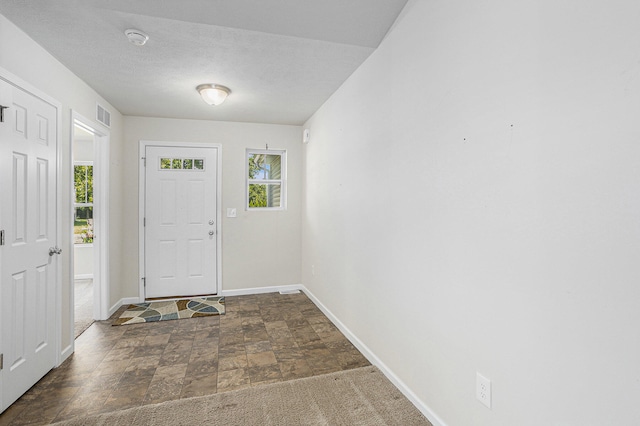 foyer featuring a textured ceiling