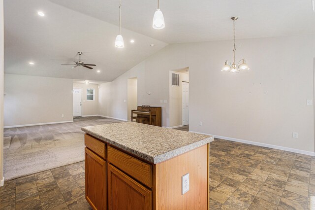 kitchen featuring a center island, decorative light fixtures, ceiling fan with notable chandelier, lofted ceiling, and dark carpet