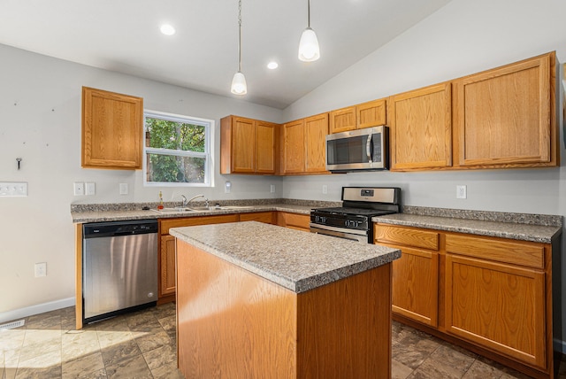 kitchen featuring a center island, stainless steel appliances, sink, hanging light fixtures, and lofted ceiling