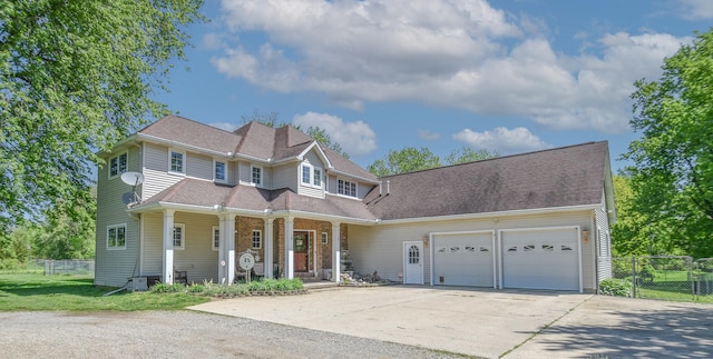 view of front of home featuring covered porch and a garage