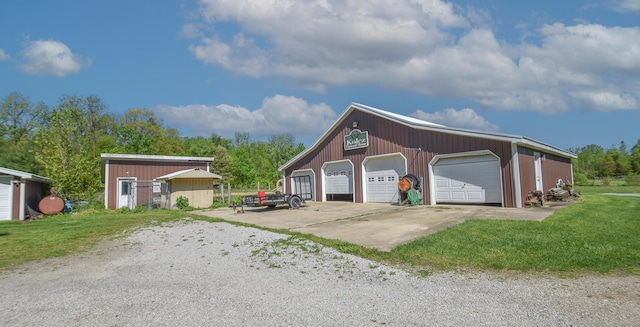 view of front of home with a front lawn, an outdoor structure, and a garage