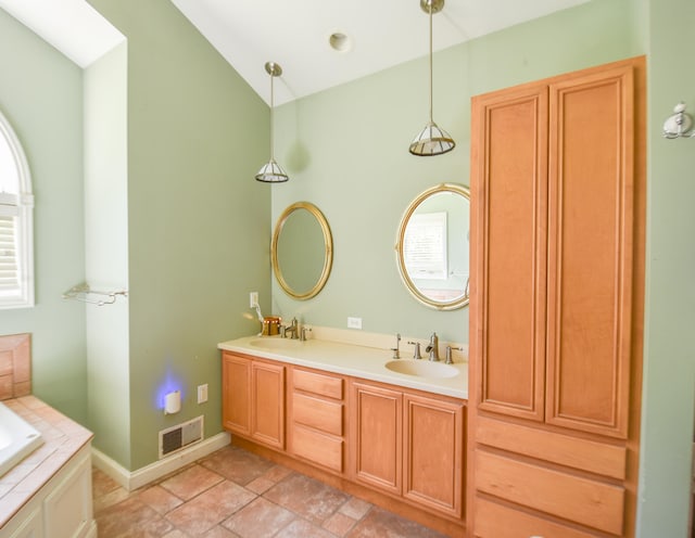 bathroom with dual sinks, tile flooring, a bathtub, large vanity, and lofted ceiling