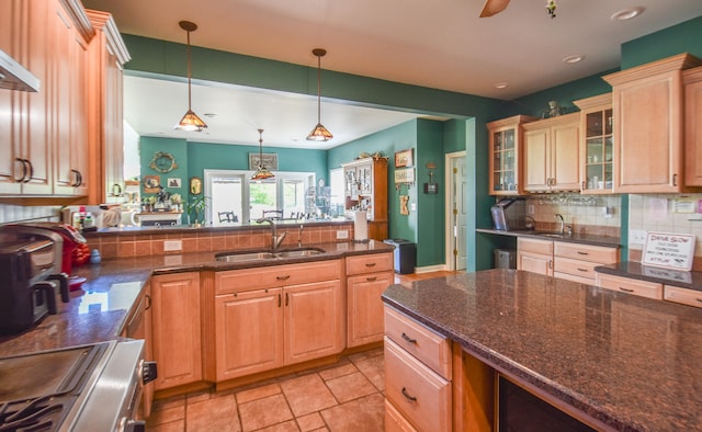 kitchen with stove, sink, tasteful backsplash, ceiling fan, and light tile floors