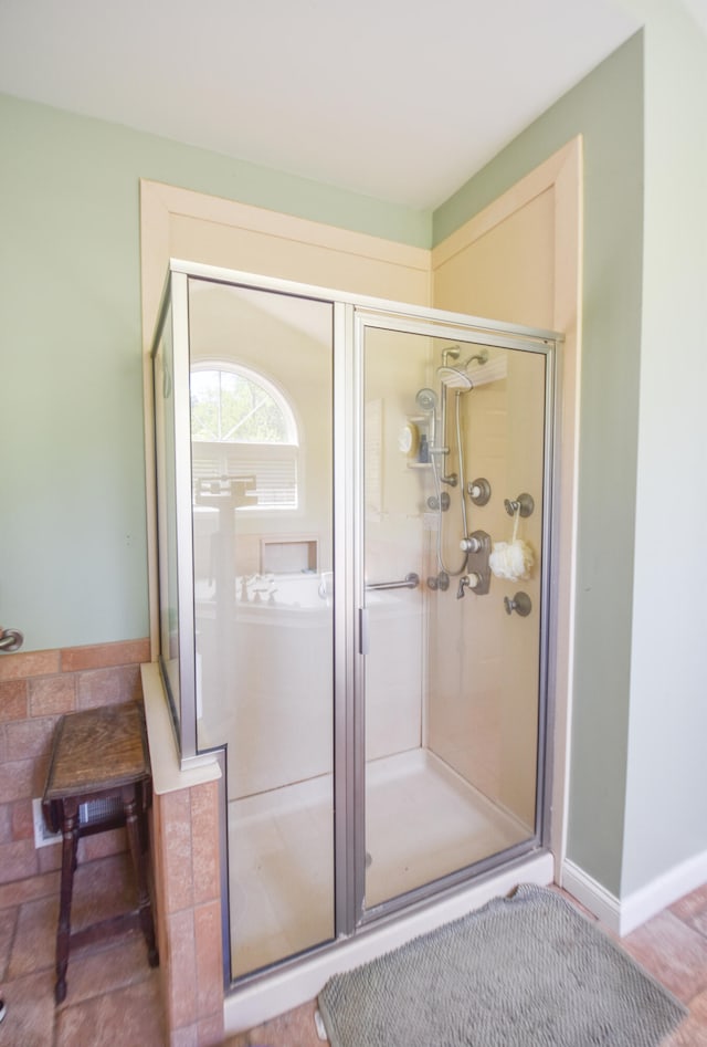 bathroom featuring hardwood / wood-style flooring and a shower with door