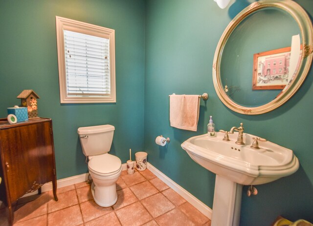 bathroom featuring tile flooring and toilet