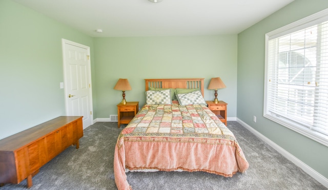 bedroom featuring dark carpet