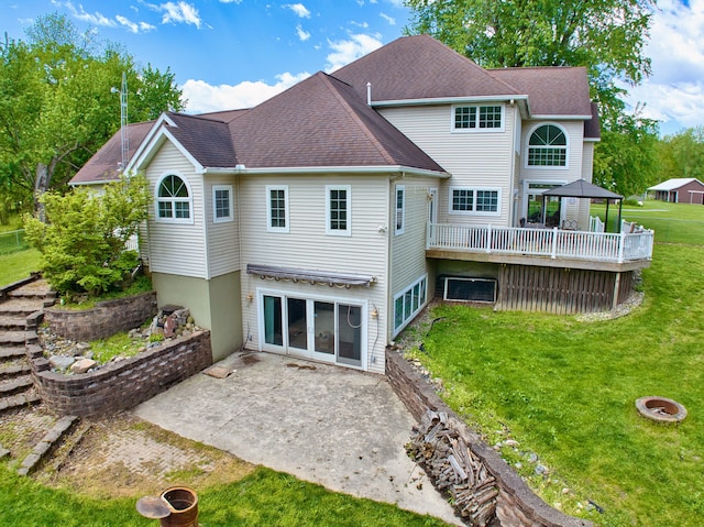 rear view of property with a patio area and a yard