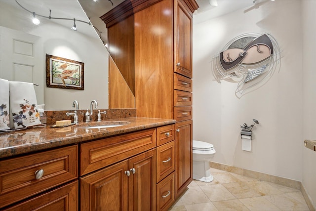 bathroom featuring tile patterned floors, vanity, and toilet