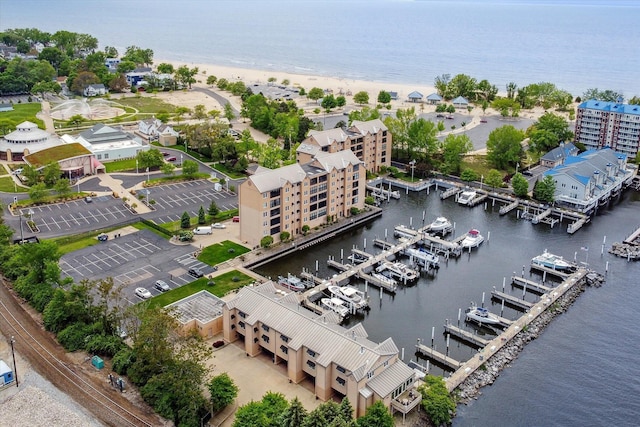 bird's eye view featuring a water view and a beach view