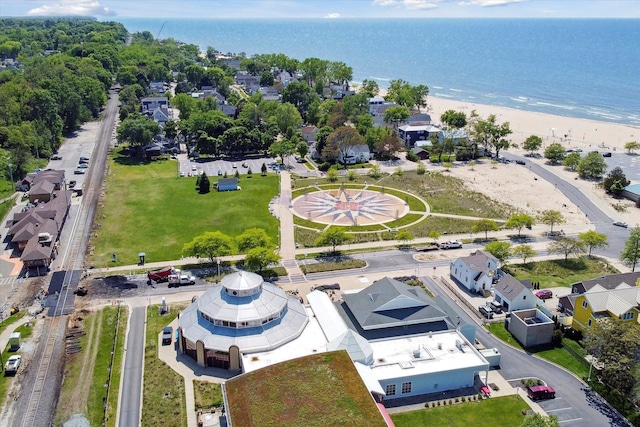 birds eye view of property with a water view and a beach view