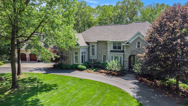 view of front of home with a garage and a front lawn