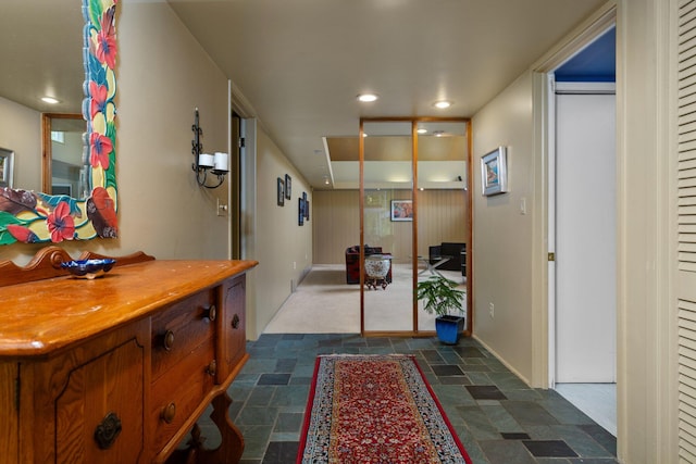 corridor featuring dark tile flooring