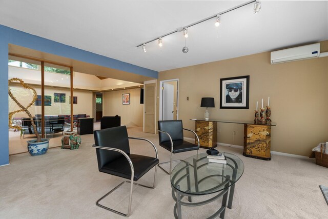 carpeted office space featuring track lighting and an AC wall unit