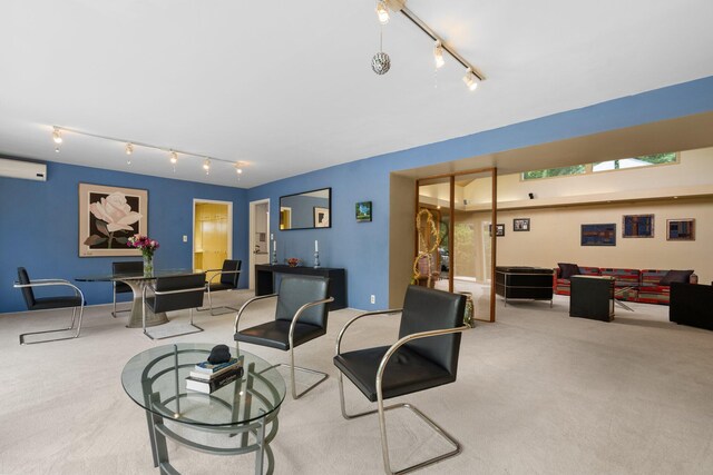 living room featuring a healthy amount of sunlight, carpet, rail lighting, and a wall mounted air conditioner