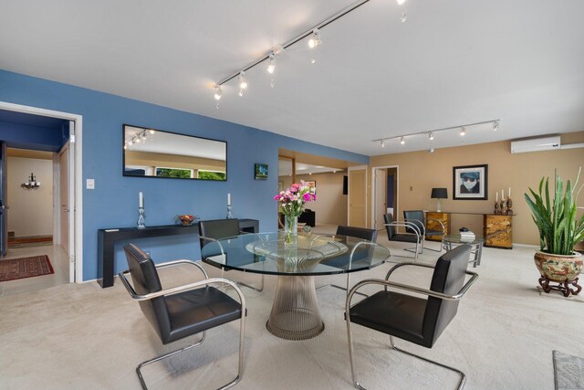 dining room featuring a wall mounted AC and rail lighting