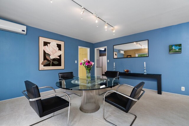 dining room with carpet flooring, track lighting, and a wall unit AC