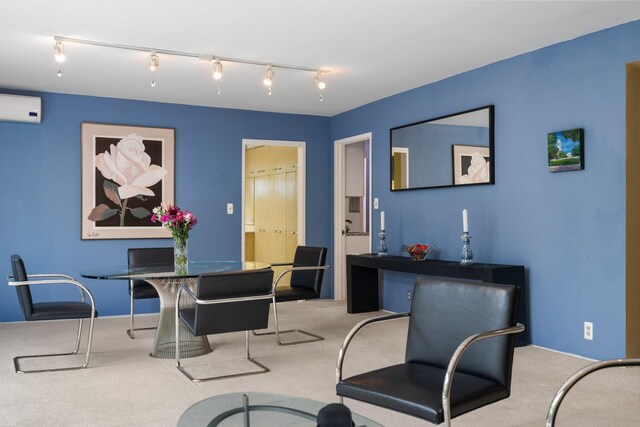 dining room featuring carpet floors, a wall unit AC, and rail lighting