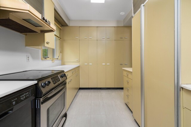 kitchen featuring cream cabinetry, light tile flooring, stainless steel range with electric stovetop, black dishwasher, and fume extractor