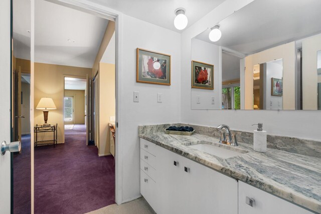 bathroom featuring a healthy amount of sunlight and vanity with extensive cabinet space