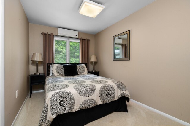 bedroom with carpet flooring and an AC wall unit