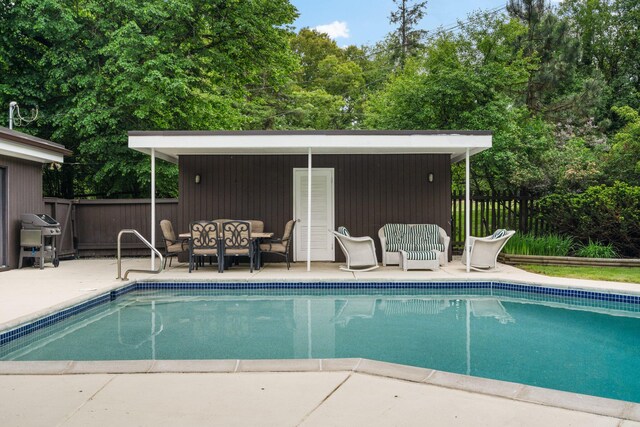 view of swimming pool with a patio area and area for grilling