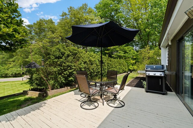 deck featuring a yard and a grill