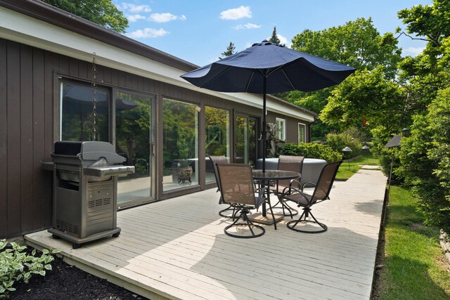 wooden deck with a grill