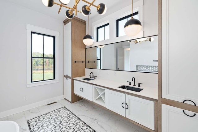 bathroom with vanity and a chandelier