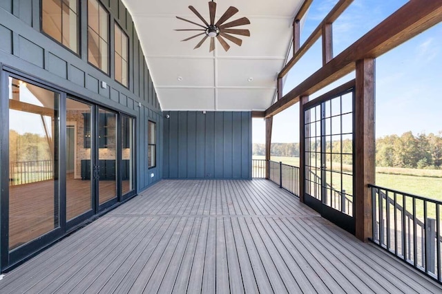 unfurnished sunroom with a wealth of natural light and ceiling fan