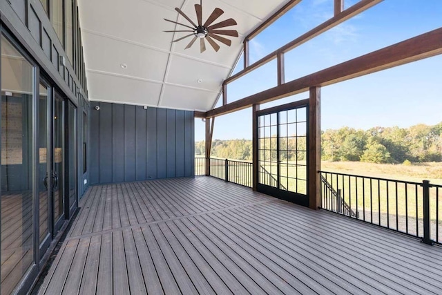 unfurnished sunroom with ceiling fan