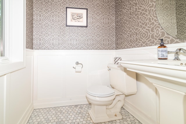 bathroom featuring tile floors and toilet