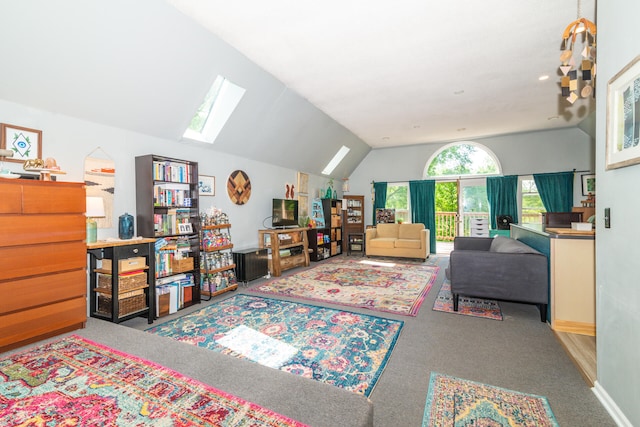 interior space with vaulted ceiling with skylight and carpet floors