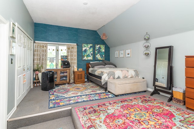 carpeted bedroom featuring a closet and vaulted ceiling