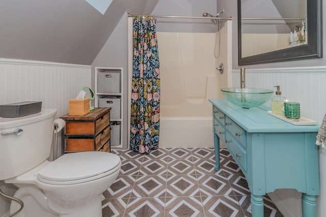 full bathroom featuring shower / tub combo, lofted ceiling with skylight, tile floors, toilet, and vanity