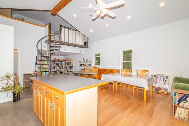 kitchen featuring a wealth of natural light, ceiling fan, light wood-type flooring, and high vaulted ceiling